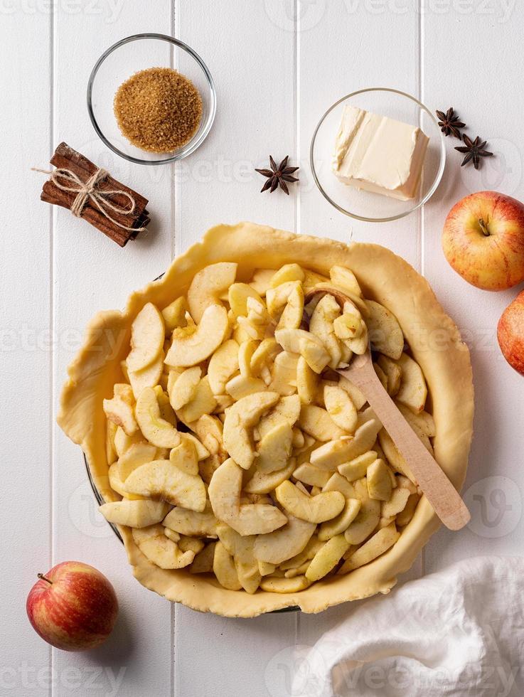 Cooking of homemade apple pie on wooden table photo