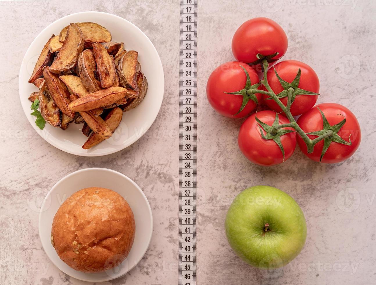 Fruit and vegetables vs sweets and potato fries top view flat lay photo