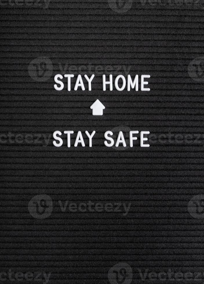 The words Stay Home, Stay Safe on black felt letter board photo