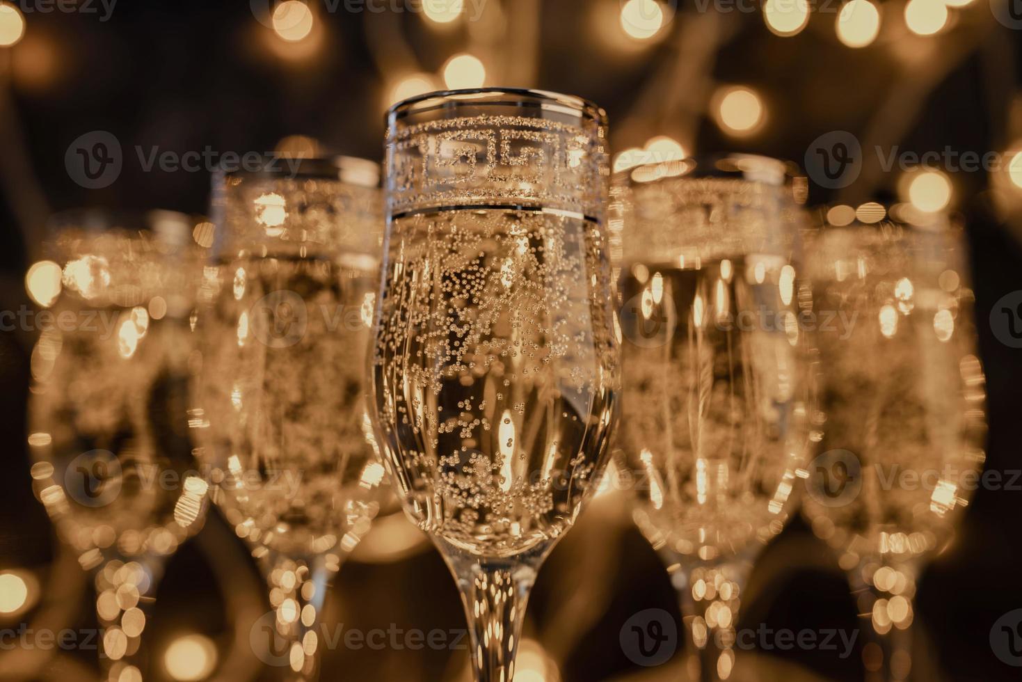 glasses of champagne on dark background with lights photo