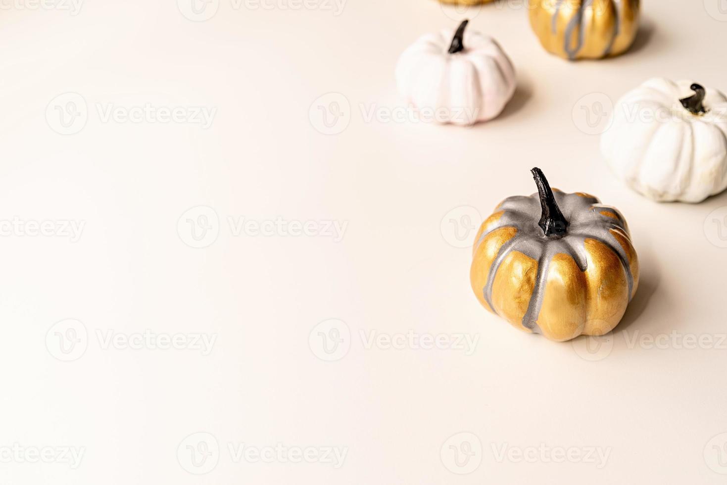 colorful painted pumpkins on white table with copy space photo