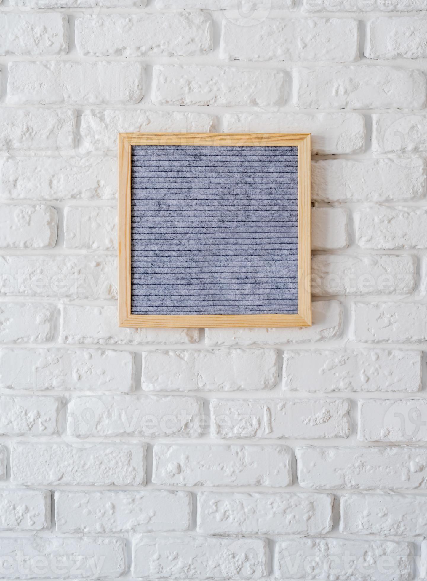 Gray felt letter board hanging on white brick wall 3733846 Stock Photo
