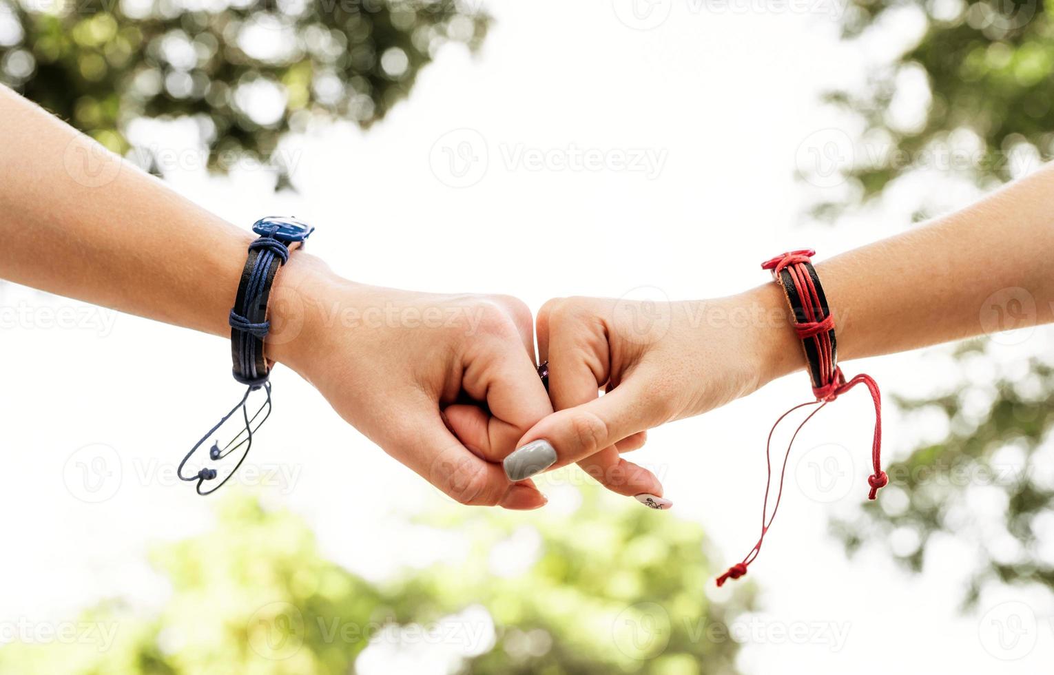 Two female fists punching each other outside photo