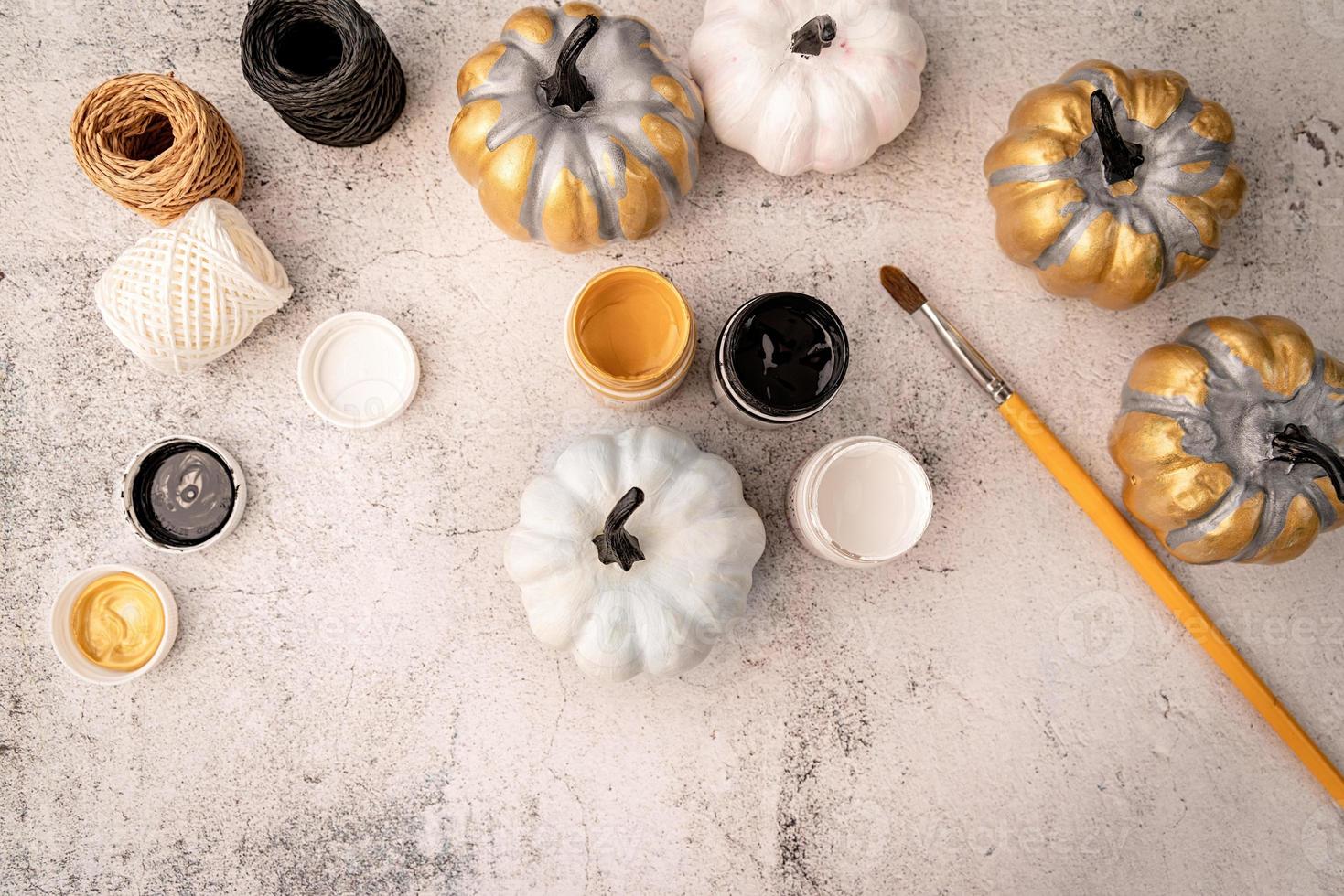 halloween colored pumpkins with paints and a brush top view flat lay photo