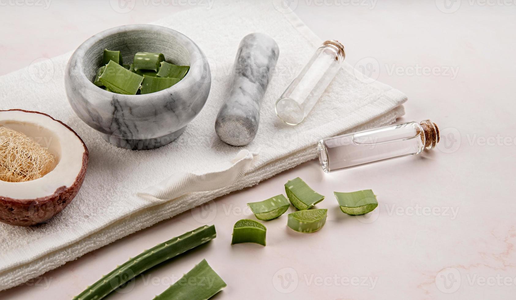 Natural cosmetics with aloe vera, sea salt and handmade coconut soap on white background photo