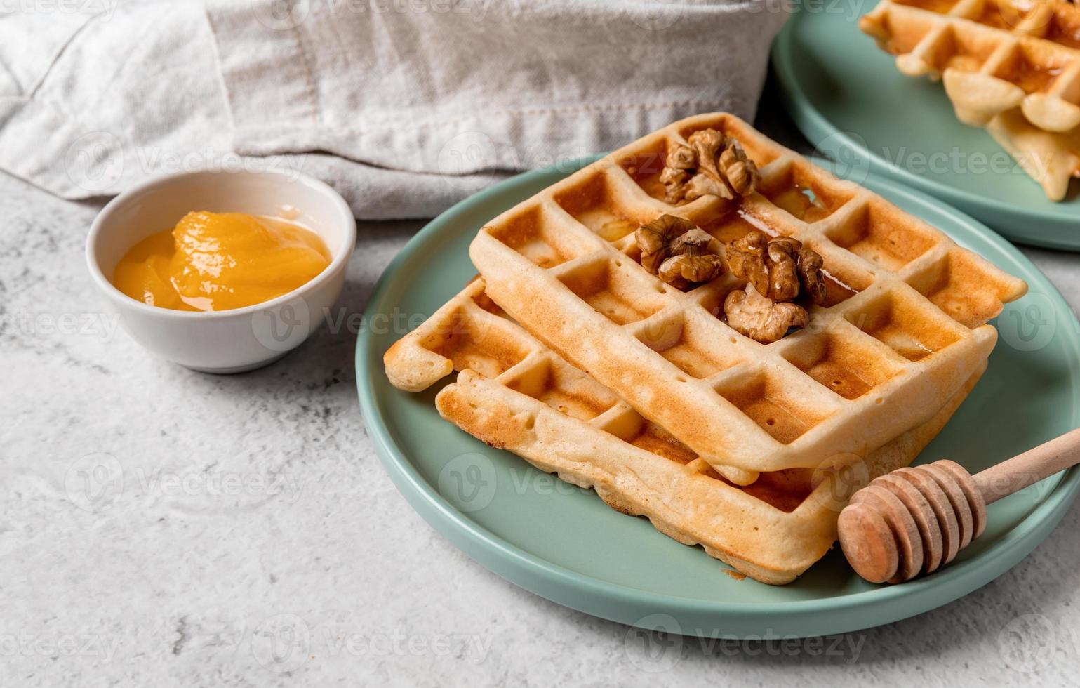 Sweet homemade waffles with walnuts and honey photo