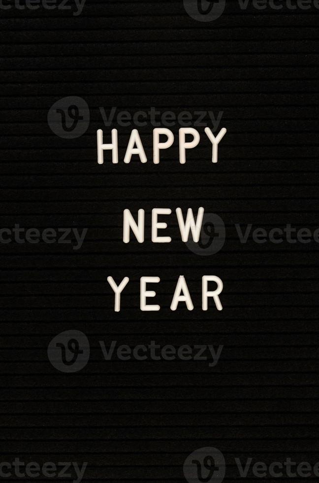 The words Happy New Year on black felt letter board photo