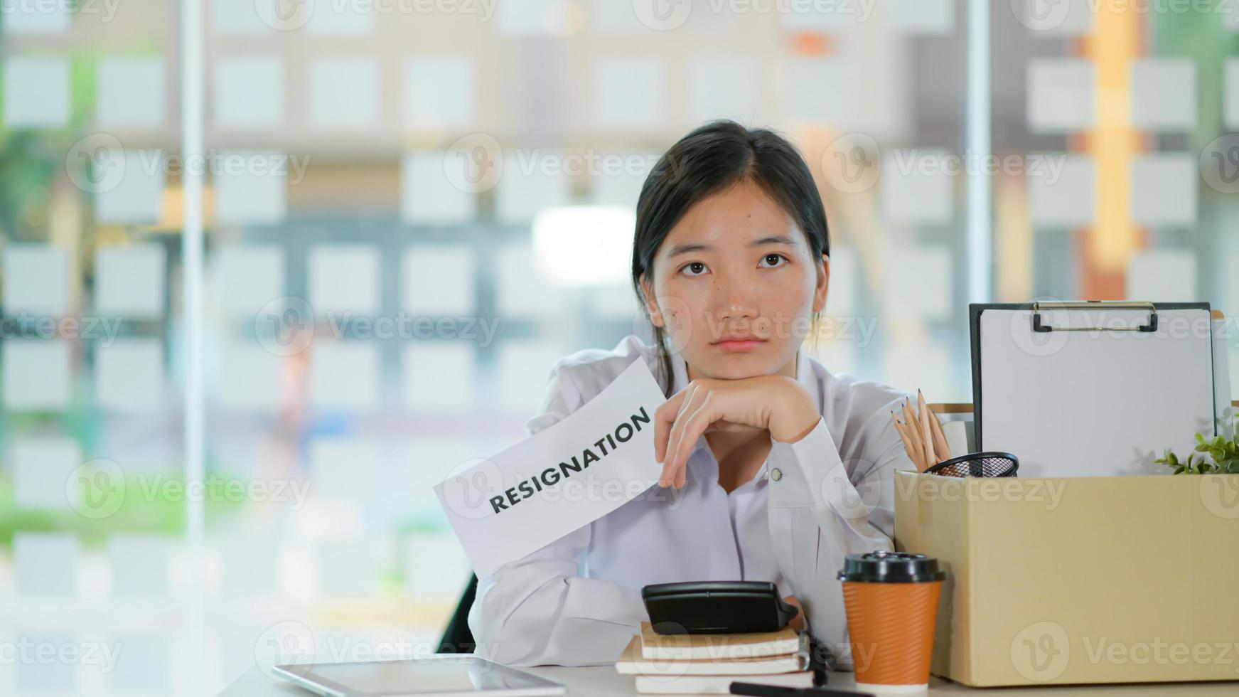 Concept of resignation, Female staff with equipment storage box after resigning. She looks serious. photo