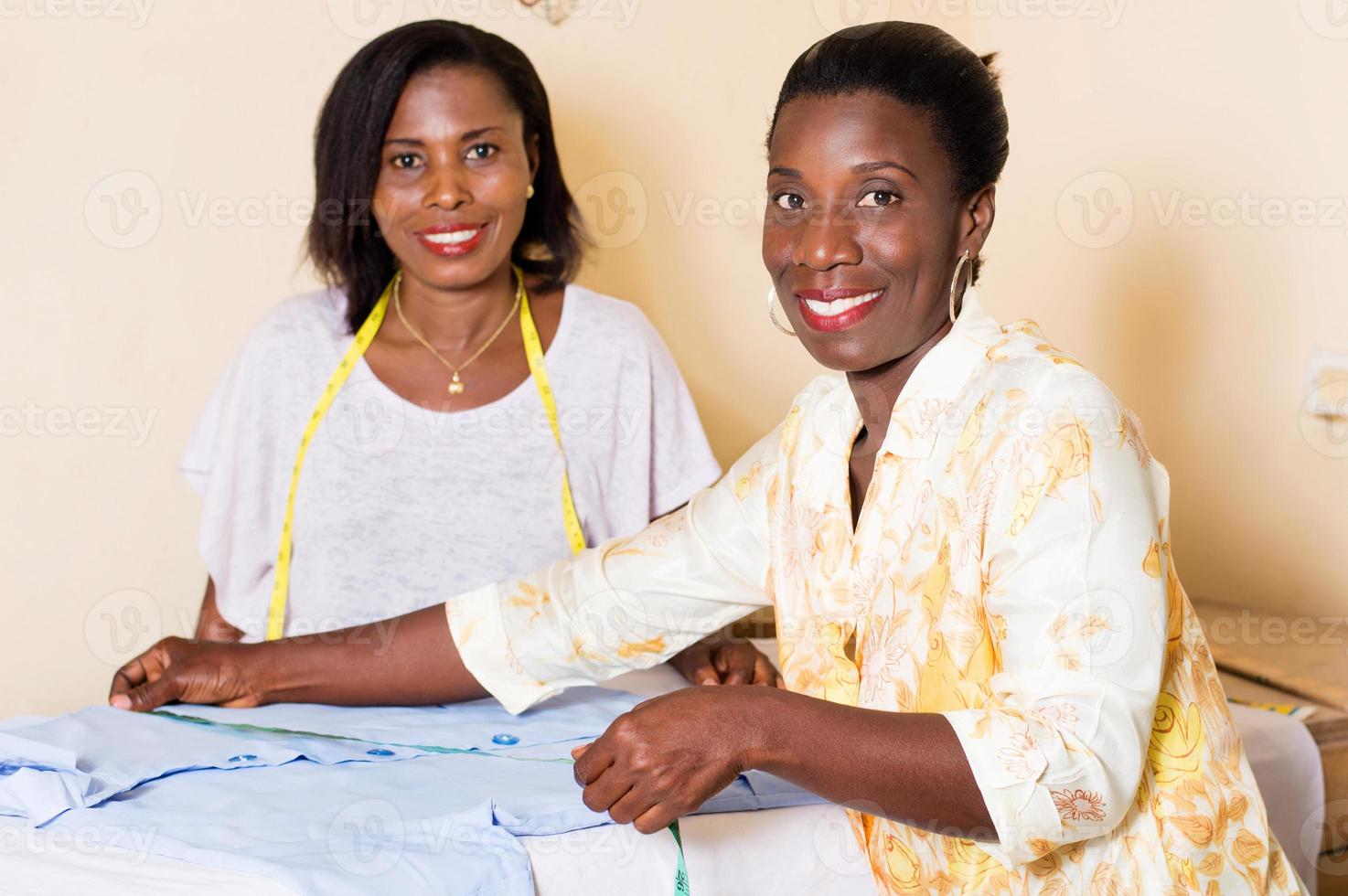 happy young seamstresses in the workshop. photo