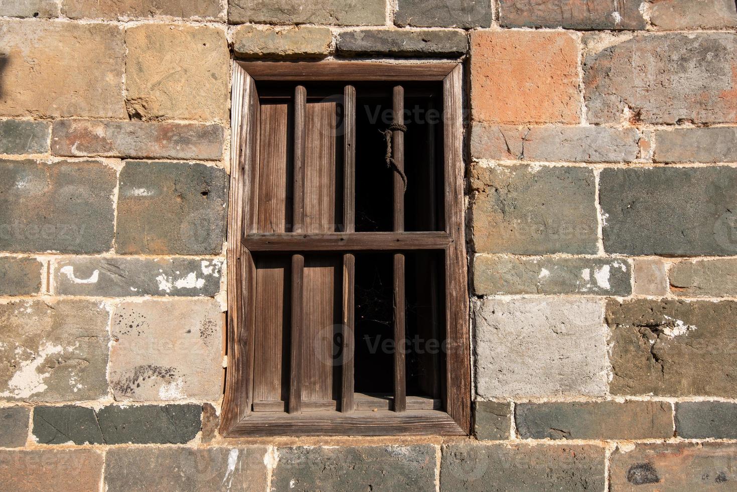 Old windows on all kinds of walls photo