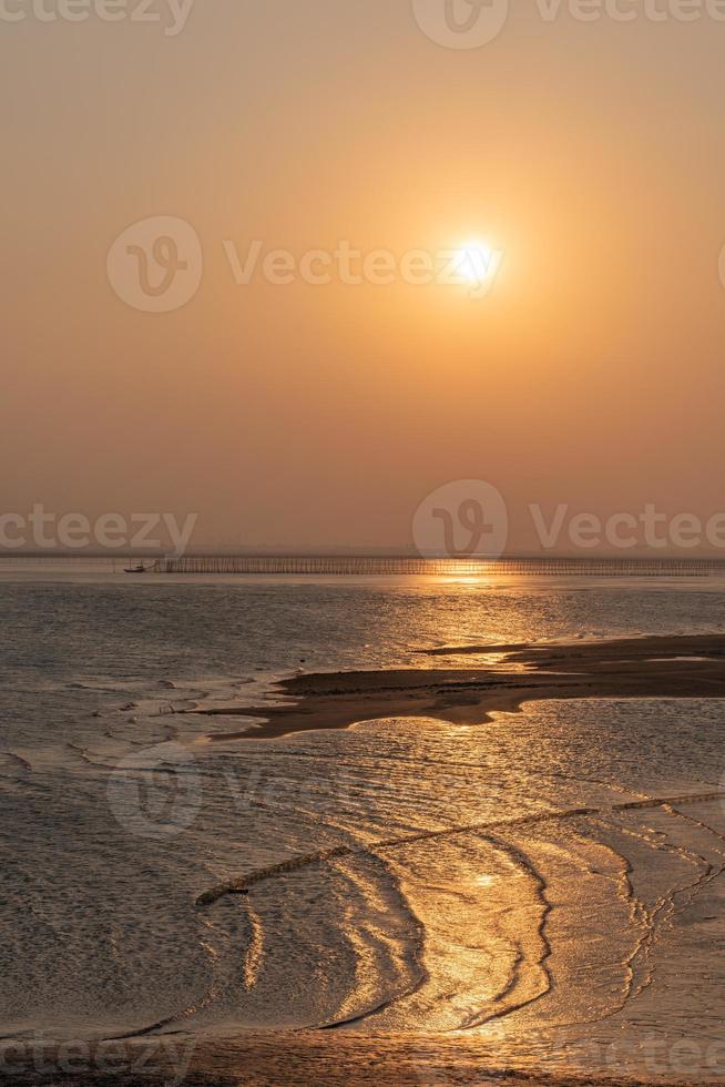 Golden beaches and fishing boats on the beach at dusk photo