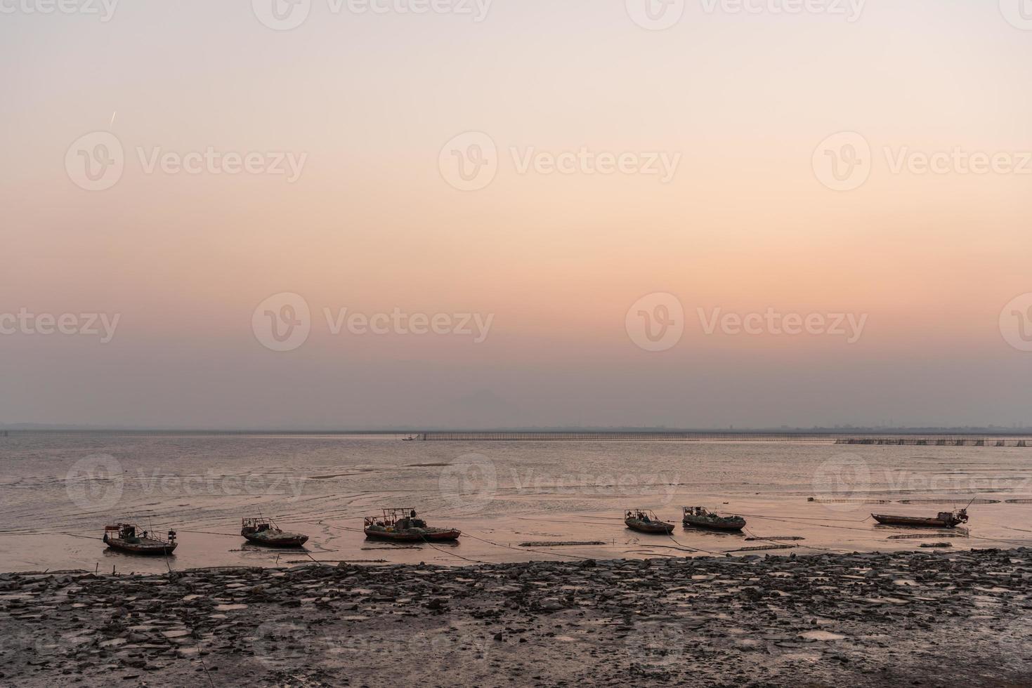 Golden beaches and fishing boats on the beach at dusk photo