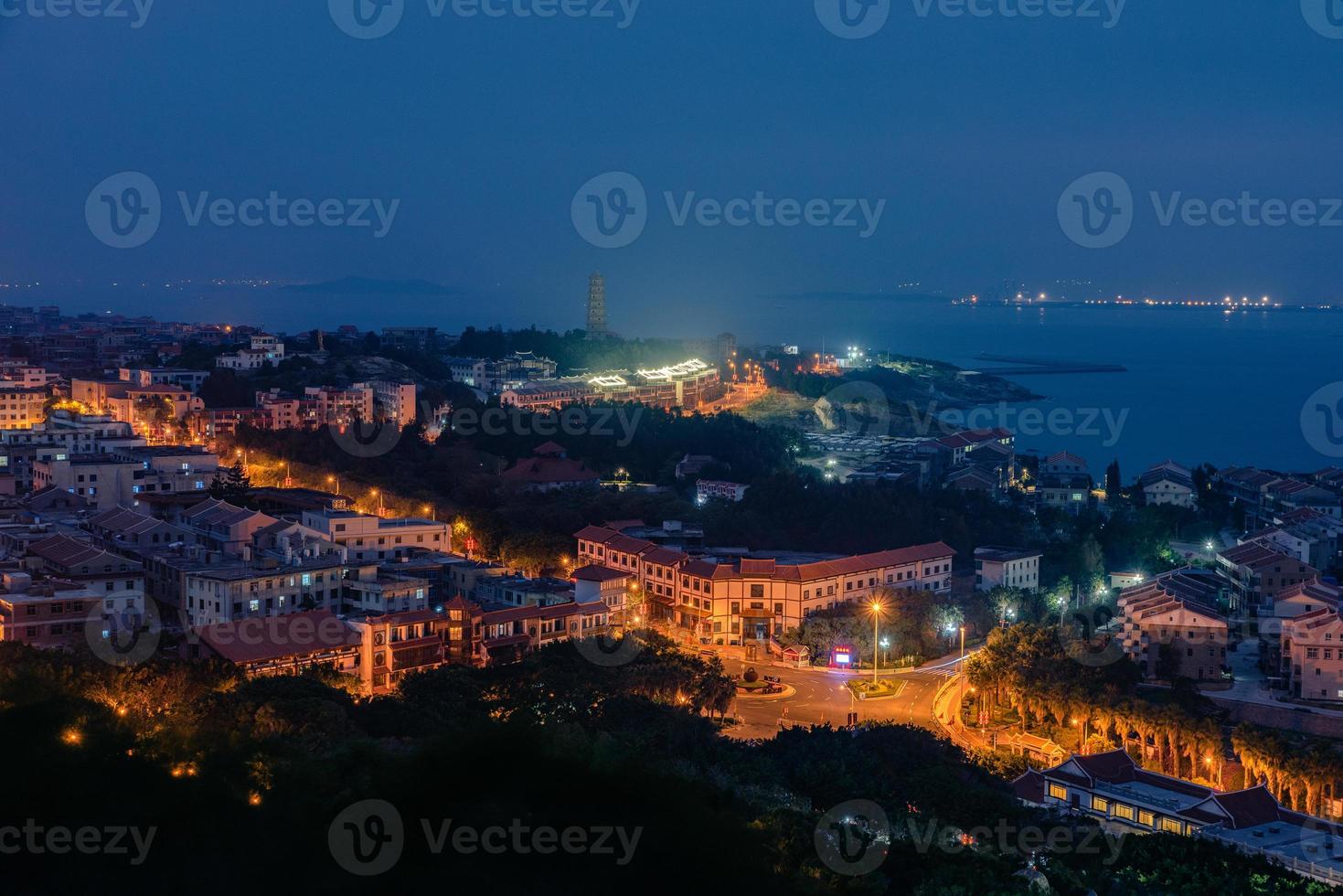 The town at night, yellow lights and blue sky photo