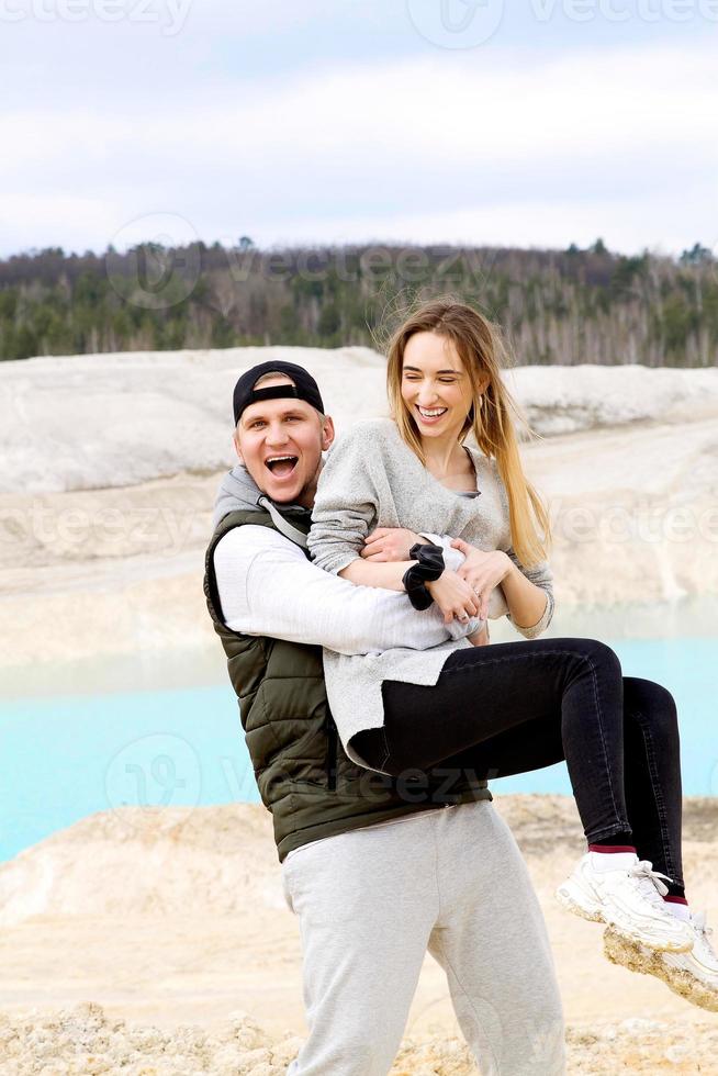 Emotional happy couple close up on the background of a blue lake outside the city photo