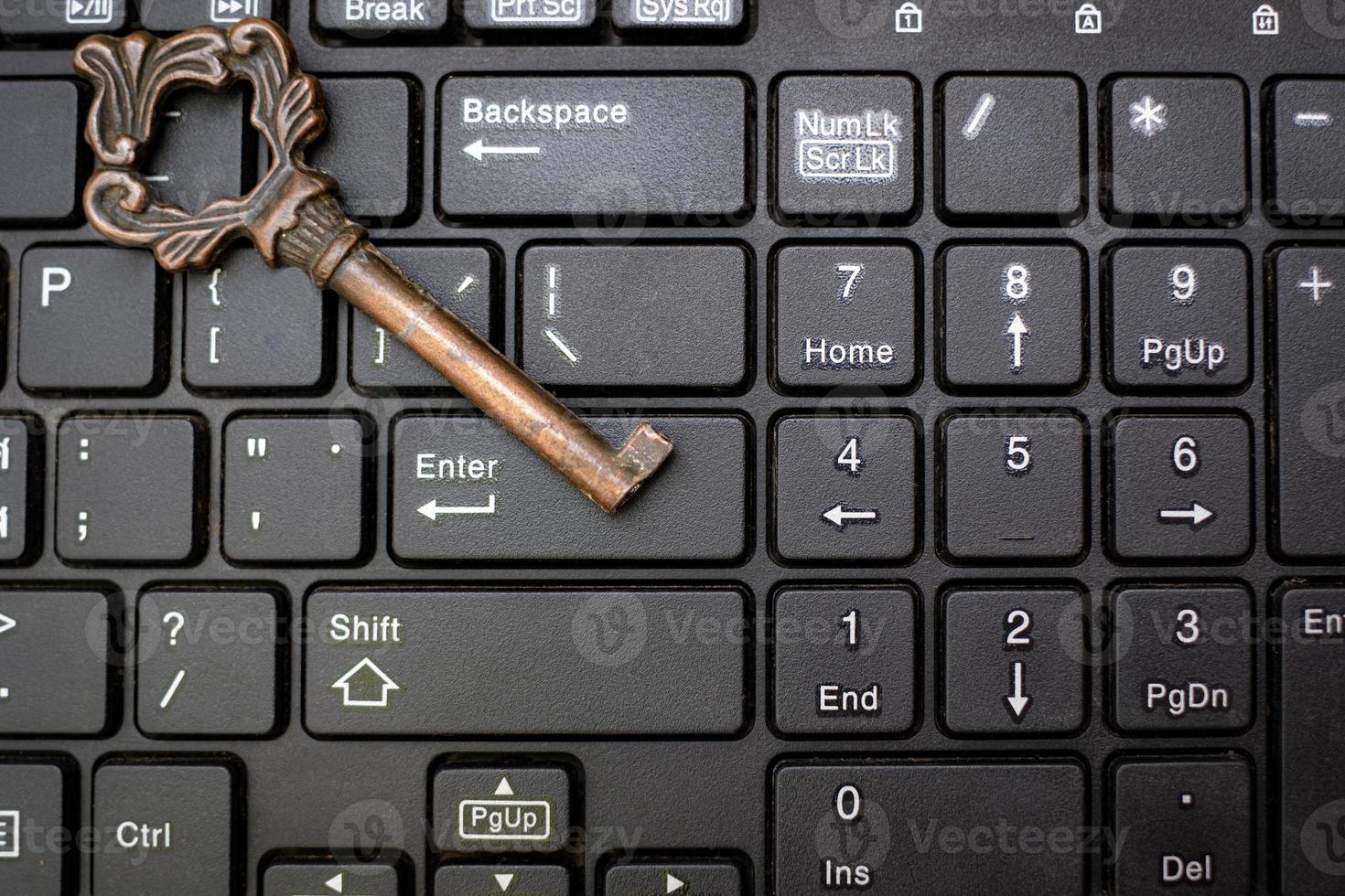 Close up old key and push-button the computer keyboard photo