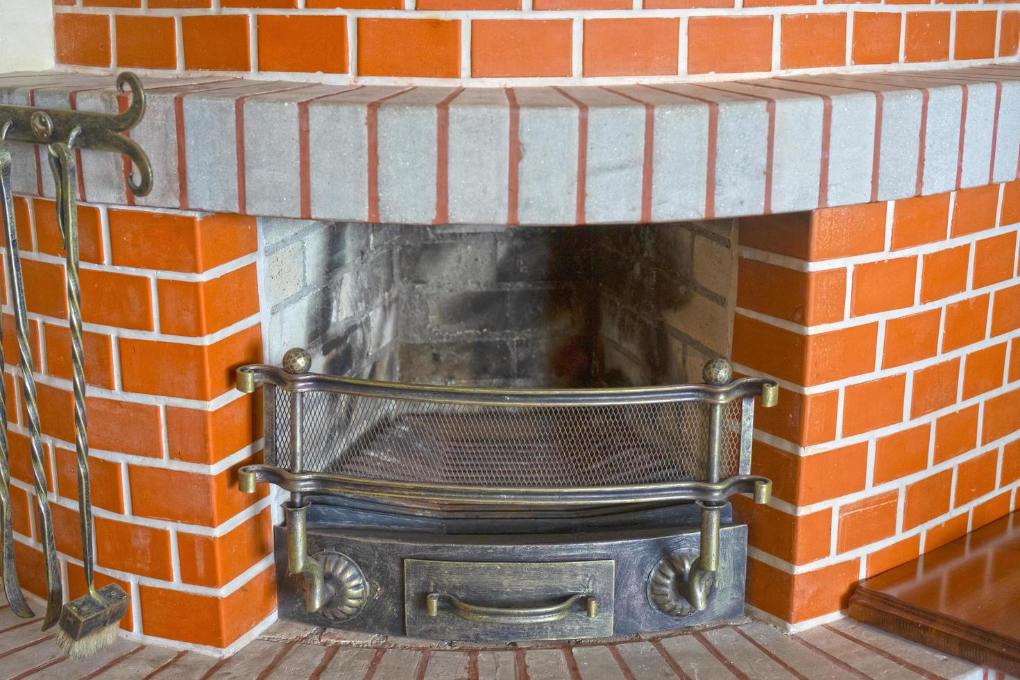 Large red brick fireplace in the interior photo