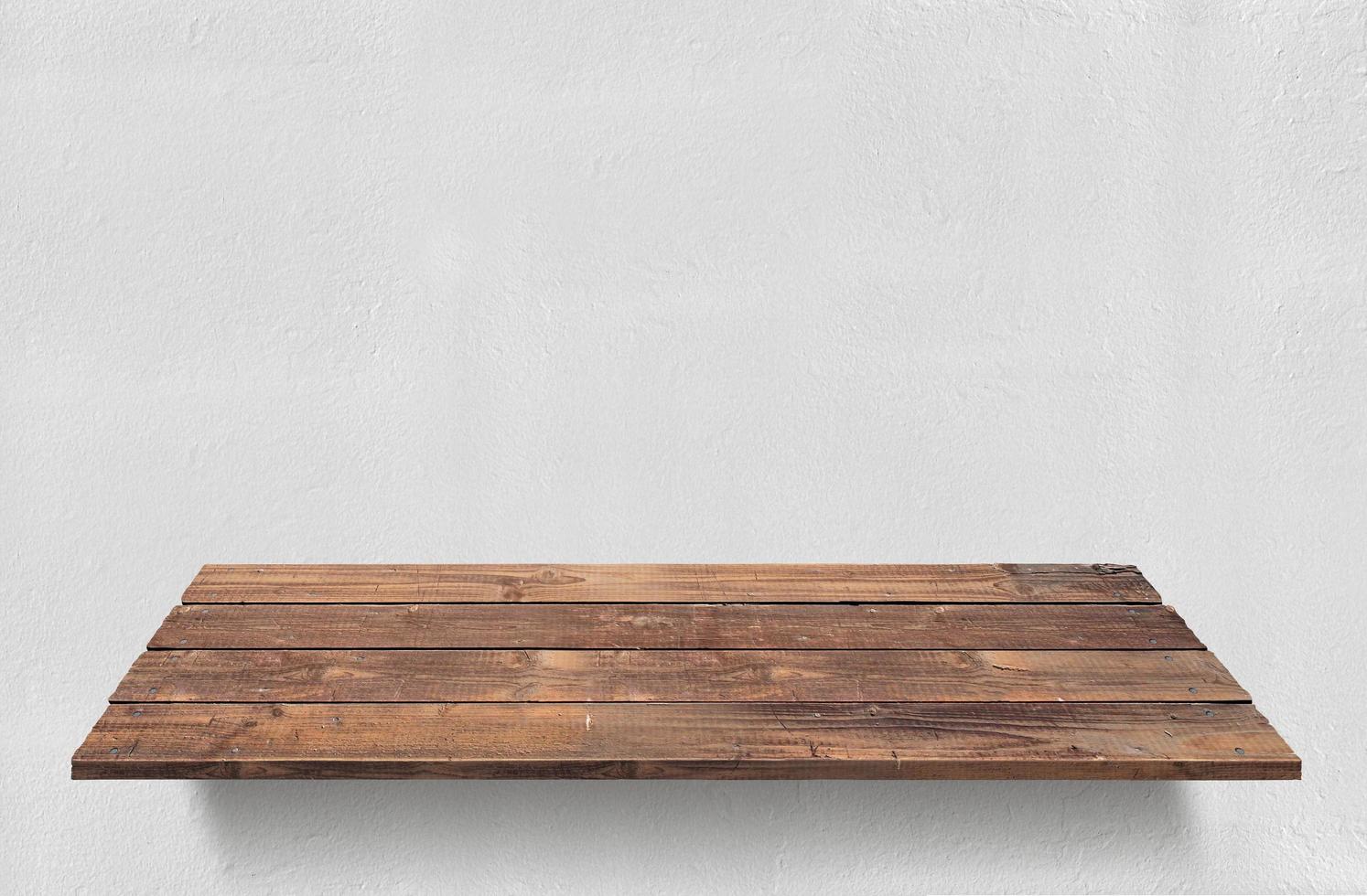 Empty wooden shelf on concrete wall. photo
