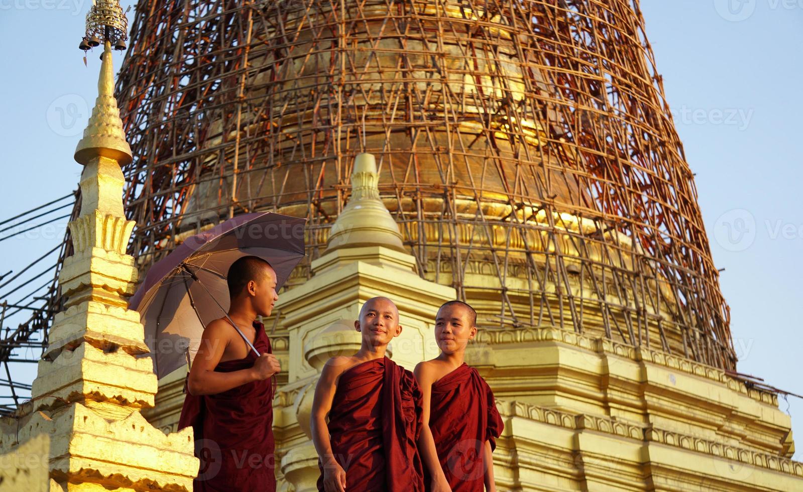 portrait of group of asian novice monk standing at monasery photo