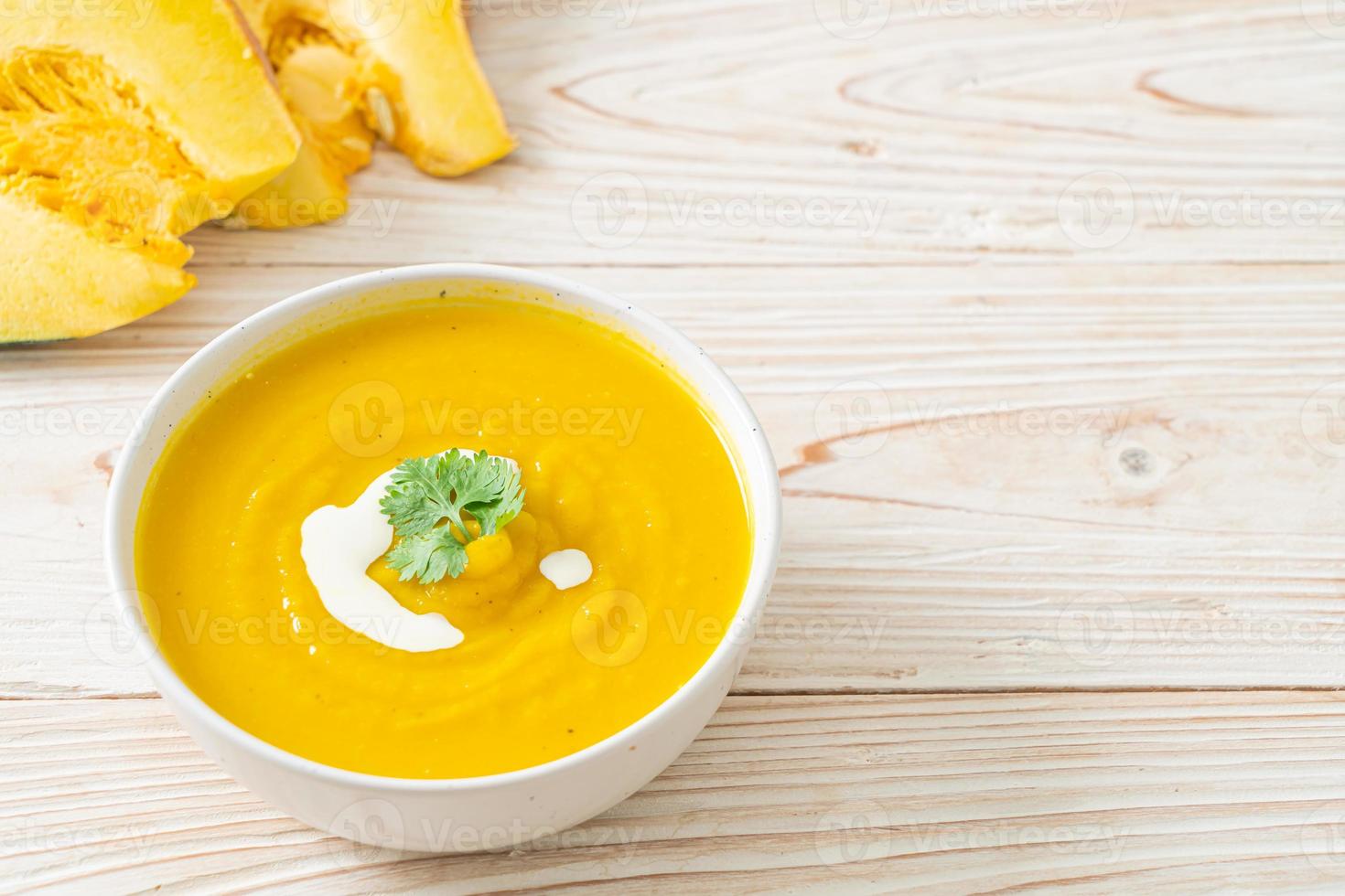 pumpkin soup in white bowl photo