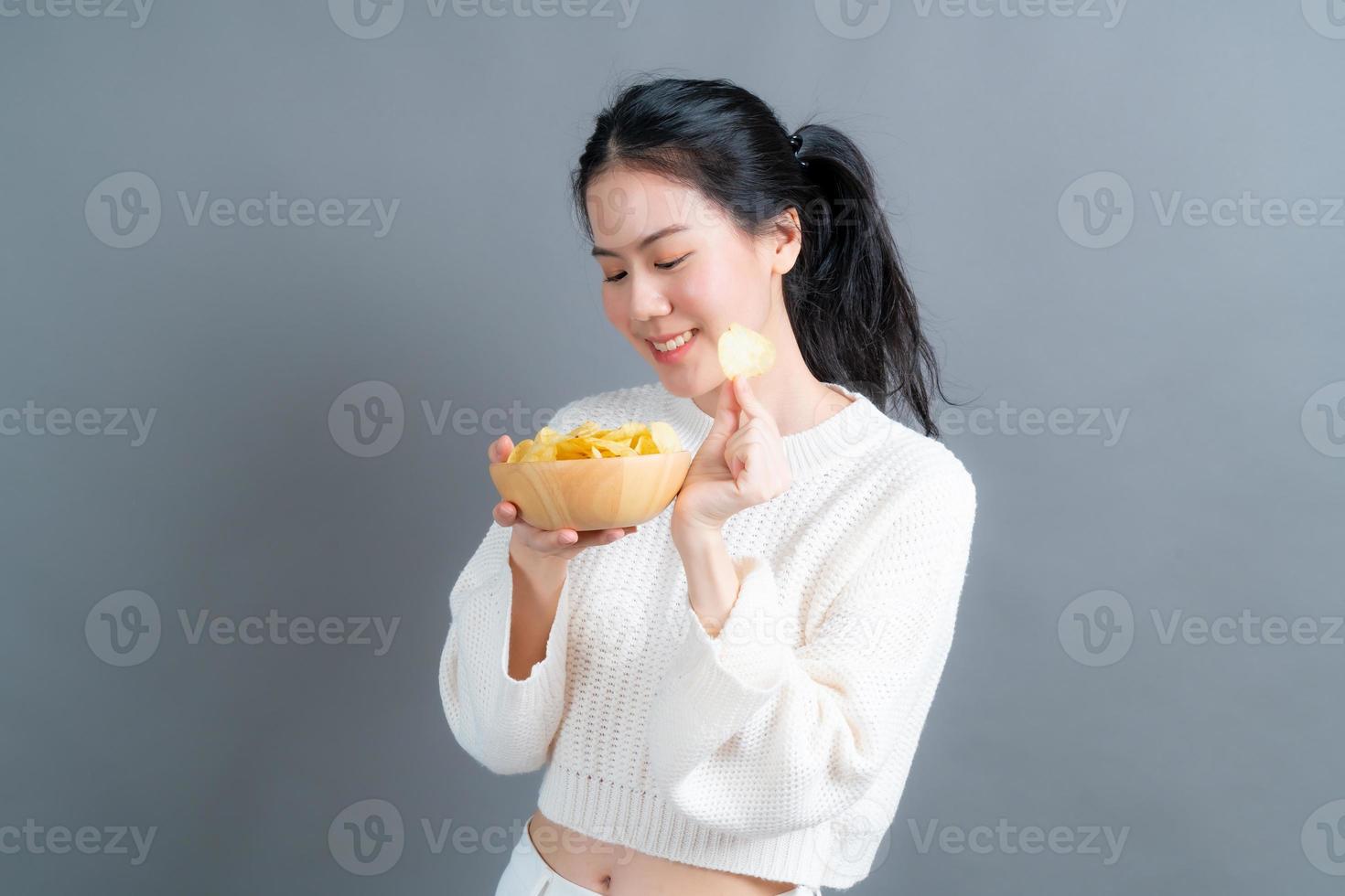 Young Asian woman eat potato chips photo