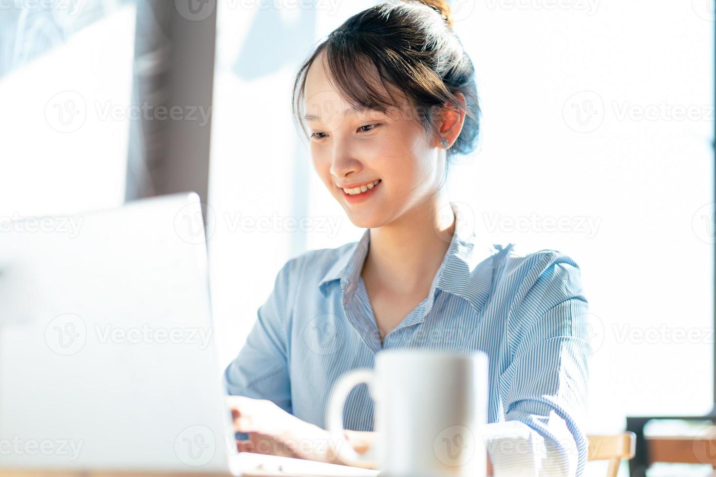 Portrait of Asian businesswoman working in a cafe photo