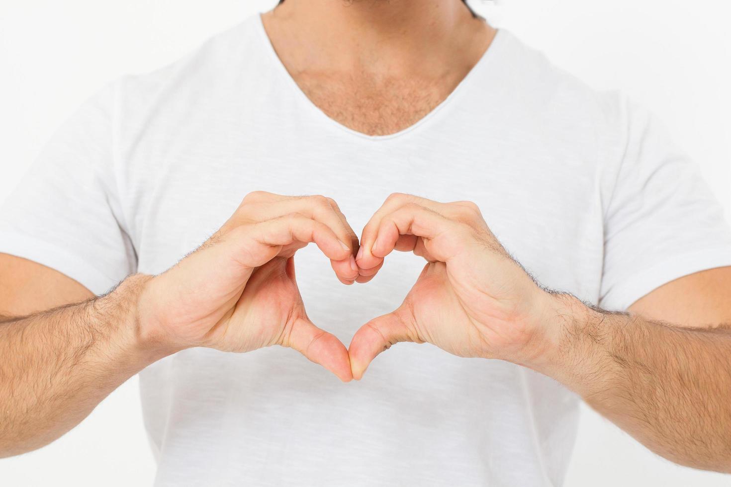 man shows a heart-shaped gesture close-up. love theme.Top view. Mock up. Copy space. Template. Blank. photo