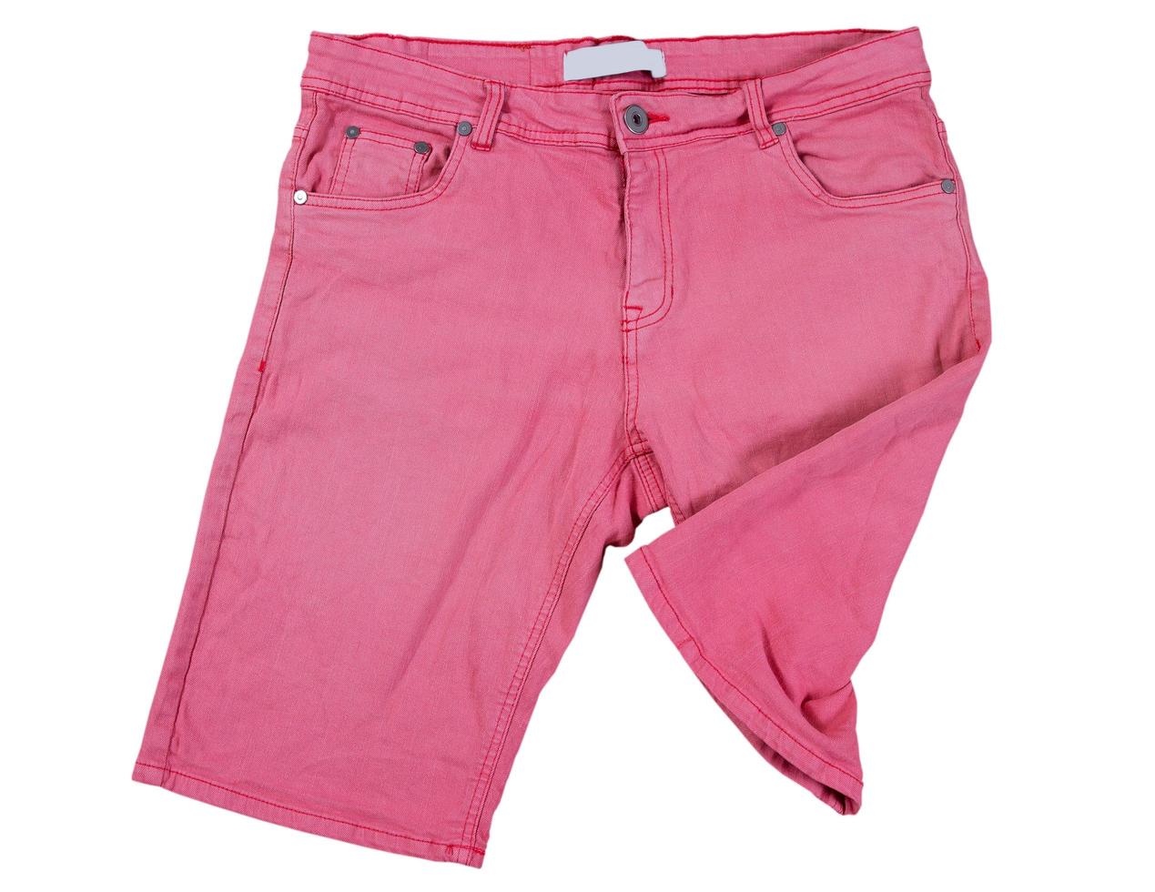 pink shorts on white background, Folded pink jeans shorts isolated over white photo