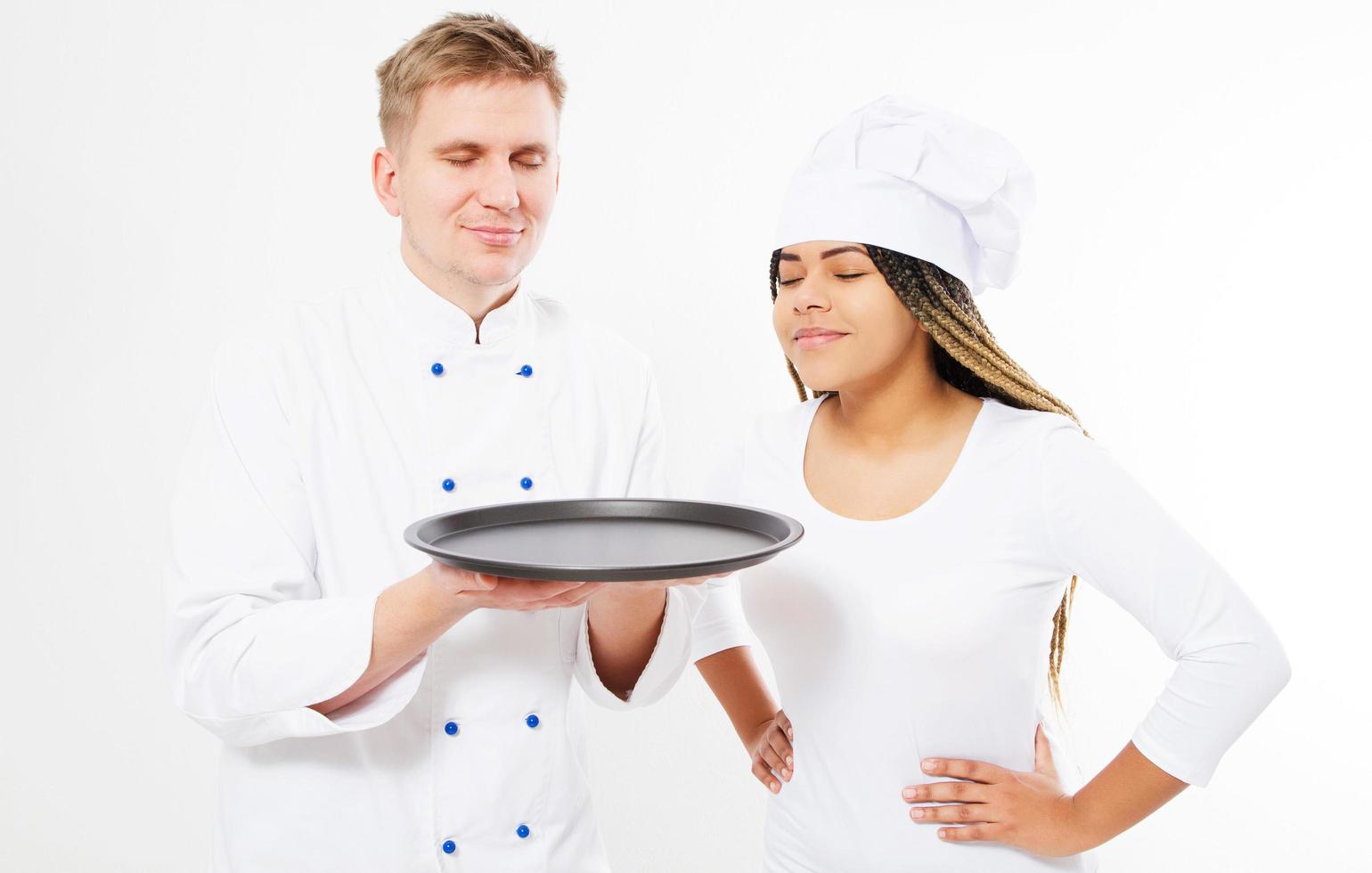 a team of chefs sniffs the pleasant aroma of something on an empty tray isolated on white photo