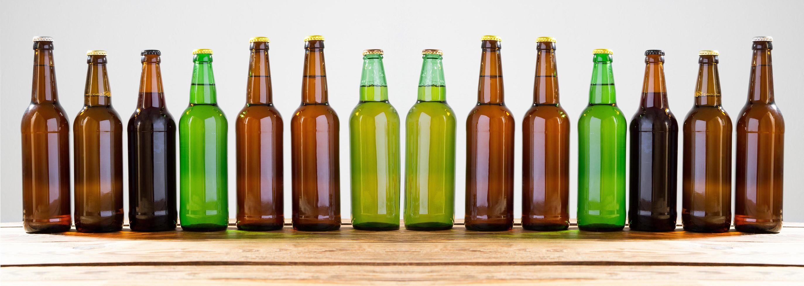 Beer bottles on a wooden table . Top view. Selective focus. Mock up. Copy space.Template. Blank. photo