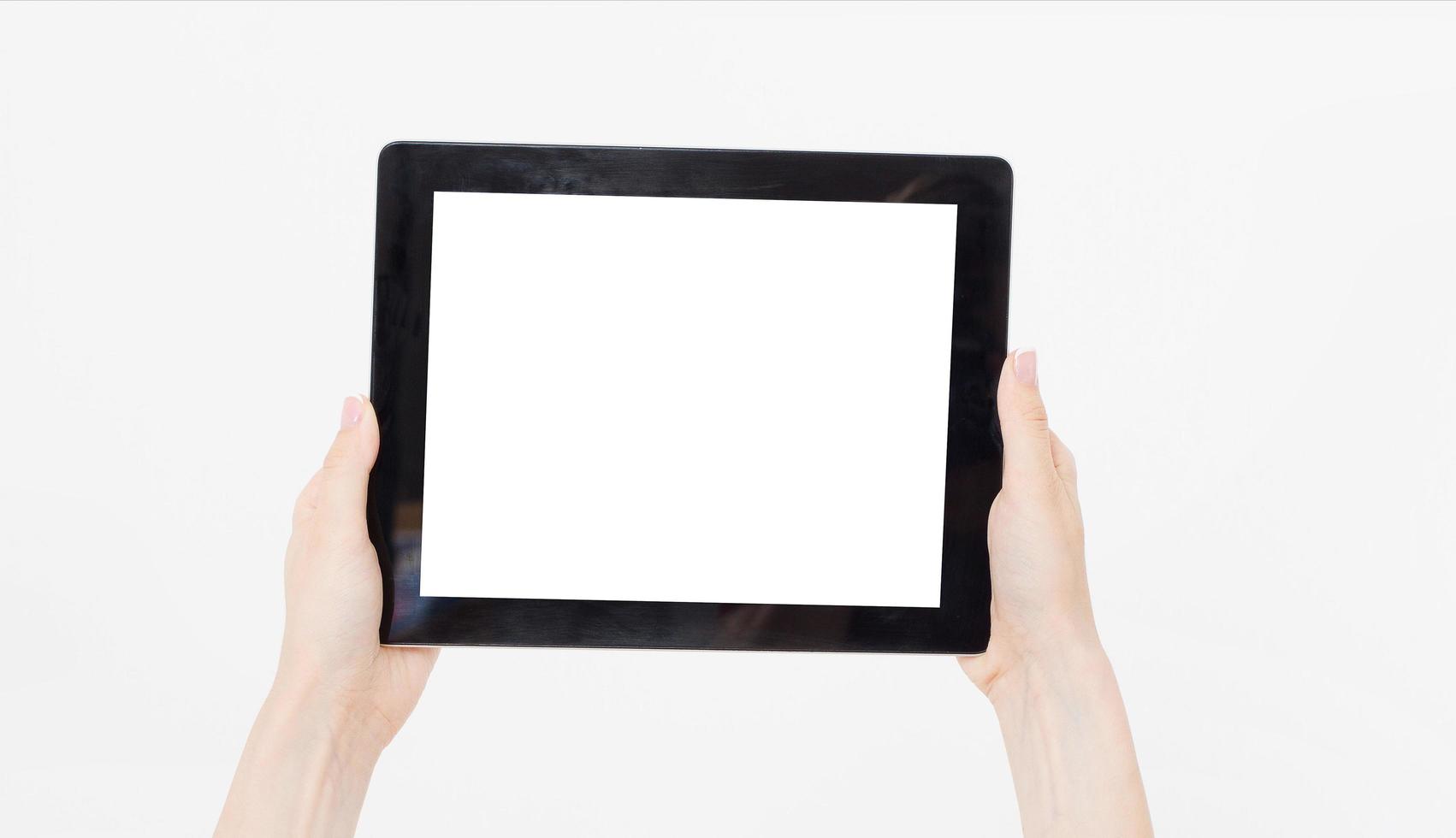 Hand holding black tablet isolated on white clipping path inside. Top view.Mock up.Copy space.Template.Blank. photo