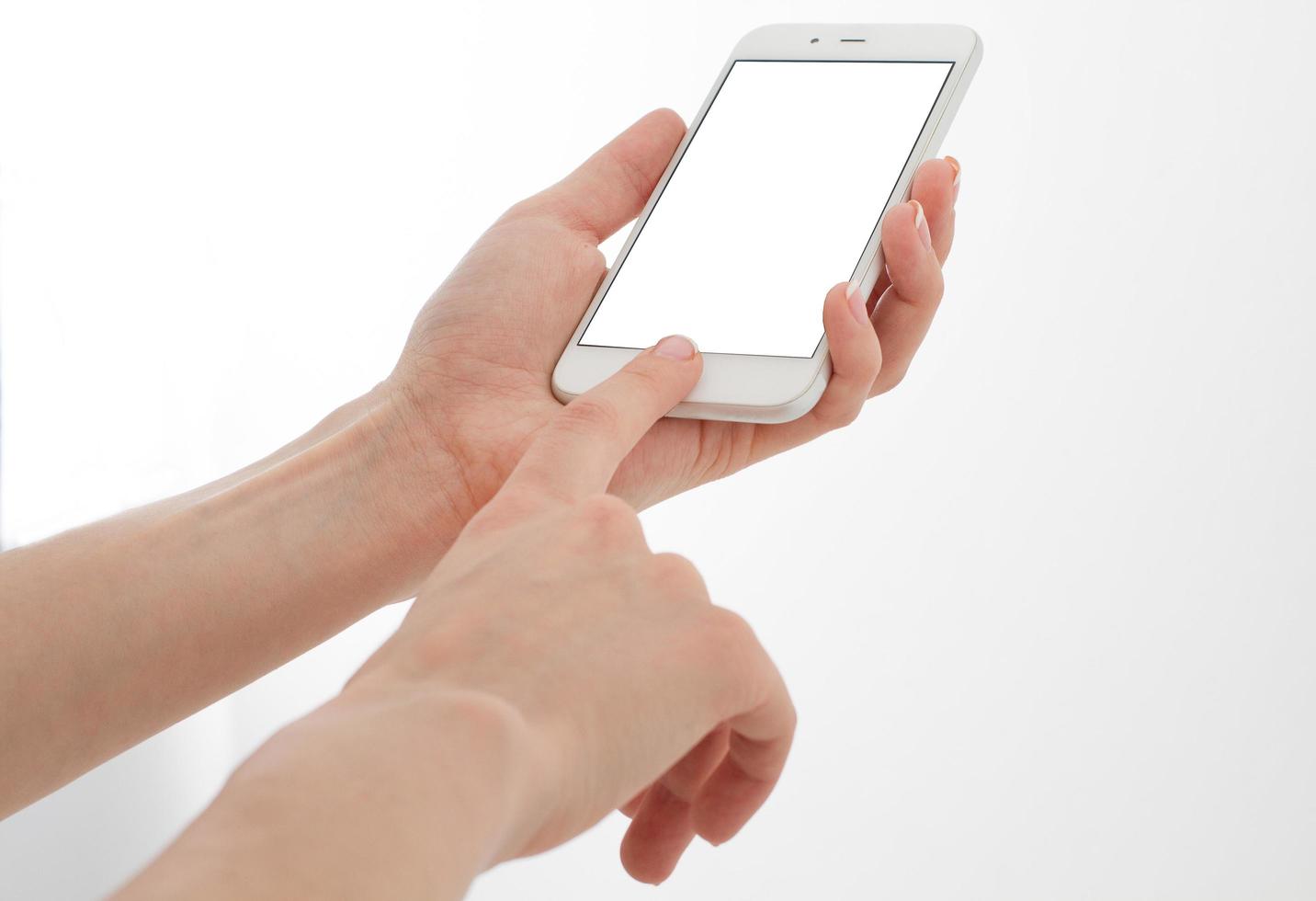 Hand holding white phone isolated on white clipping path inside. Top view.Mock up.Copy space.Template.Blank. photo