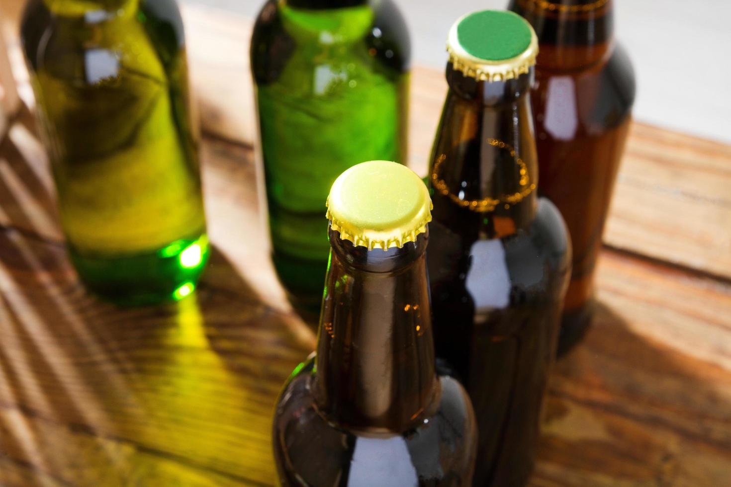 Beer bottles on a wooden table . Top view. Selective focus. Mock up. Copy space.Template. Blank. photo