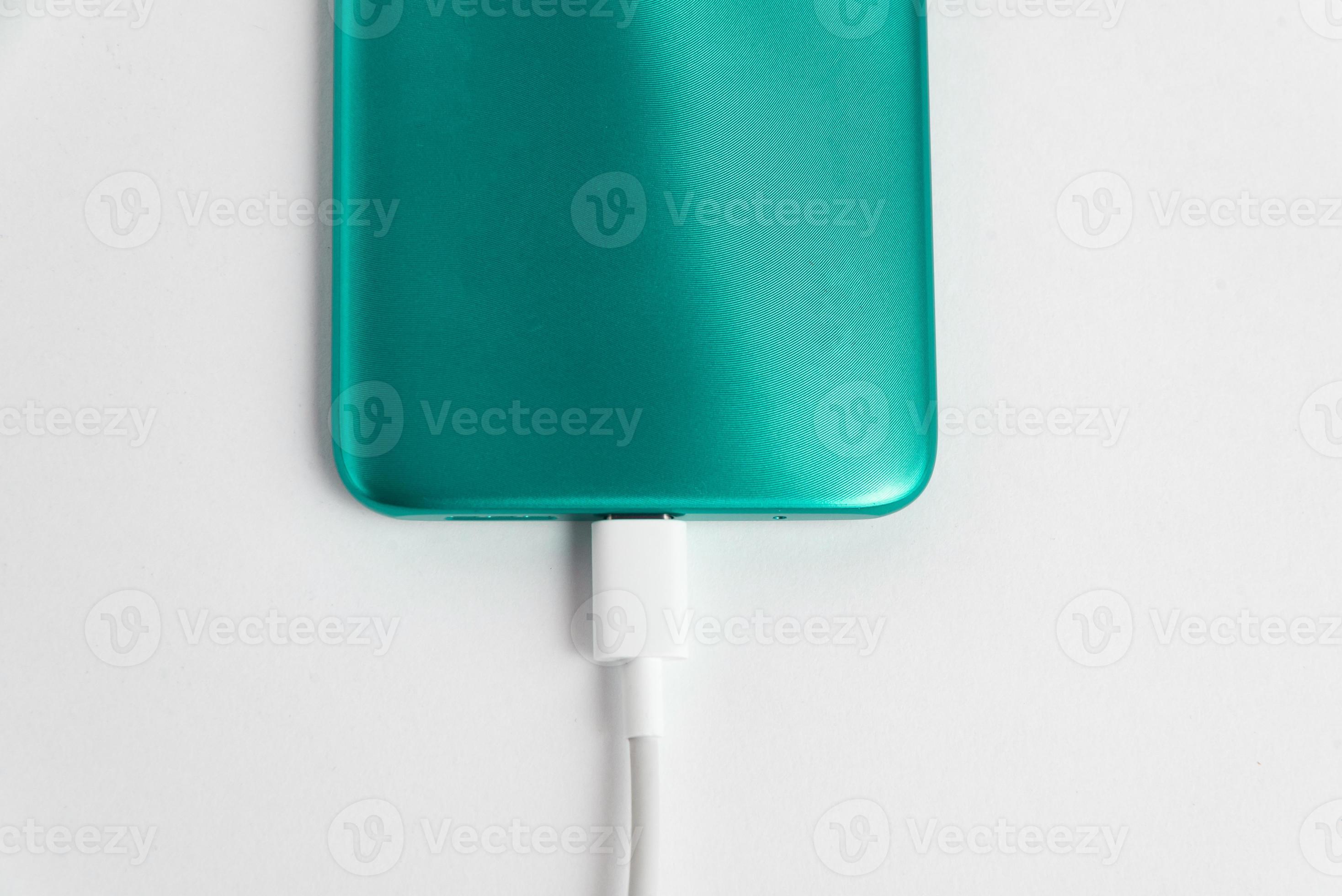 teléfono celular verde conectado al cable usb tipo c - cargando foto