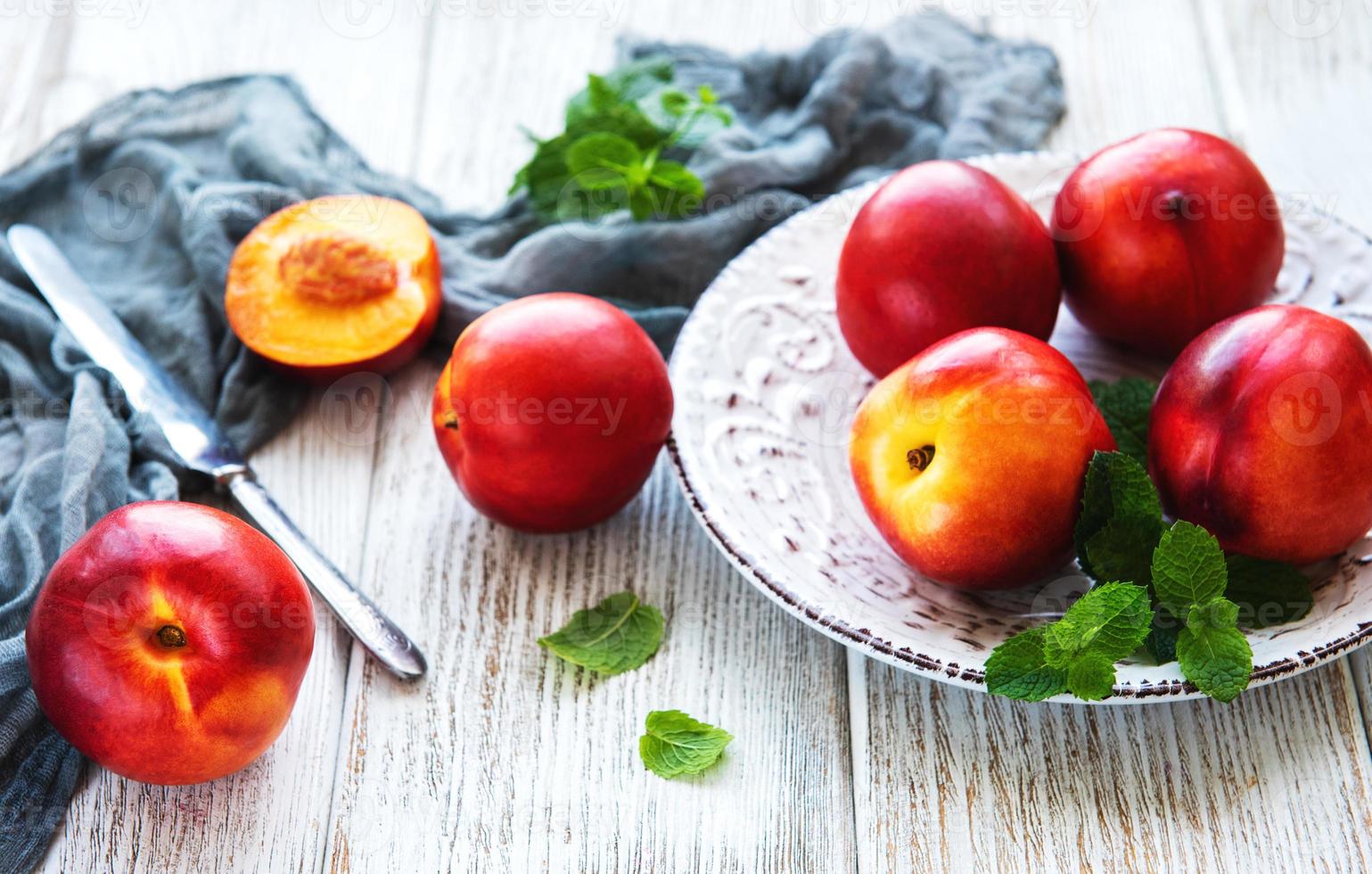 Plate with fresh nectarines photo