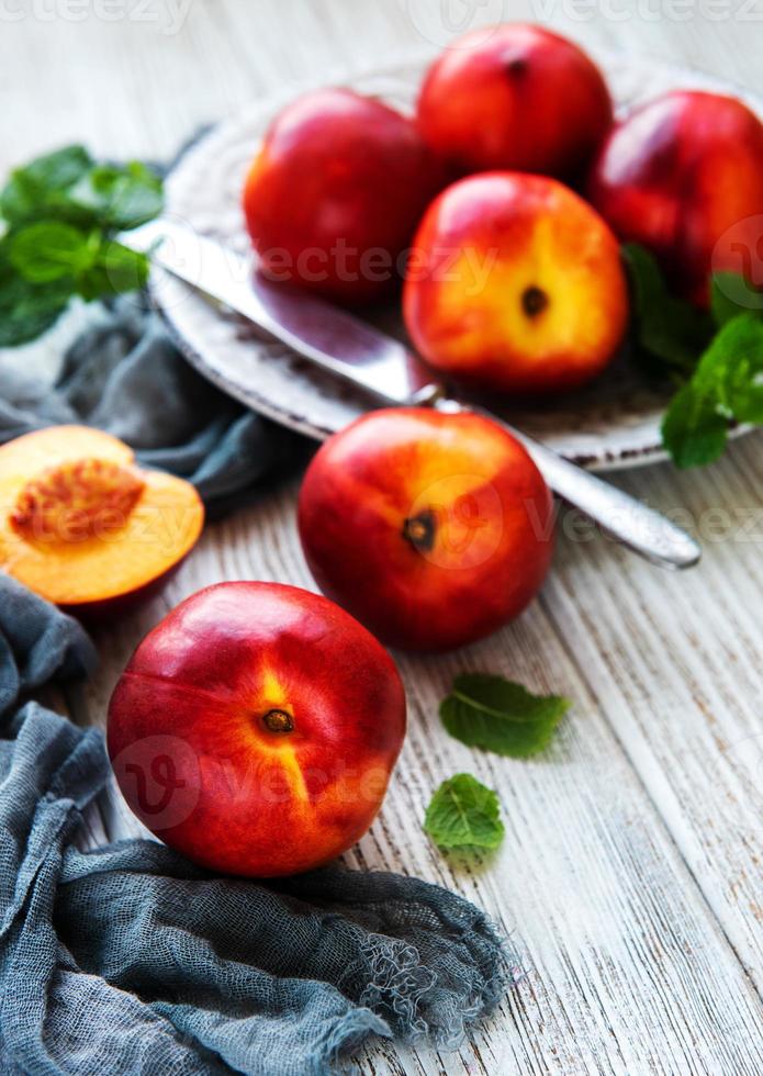 Plate with fresh nectarines photo