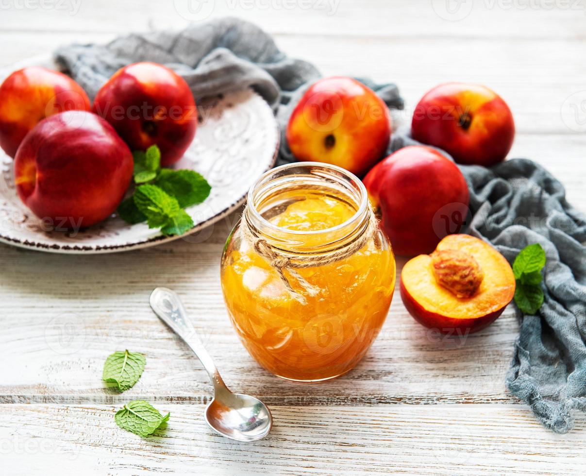 Nectarine jam on table photo