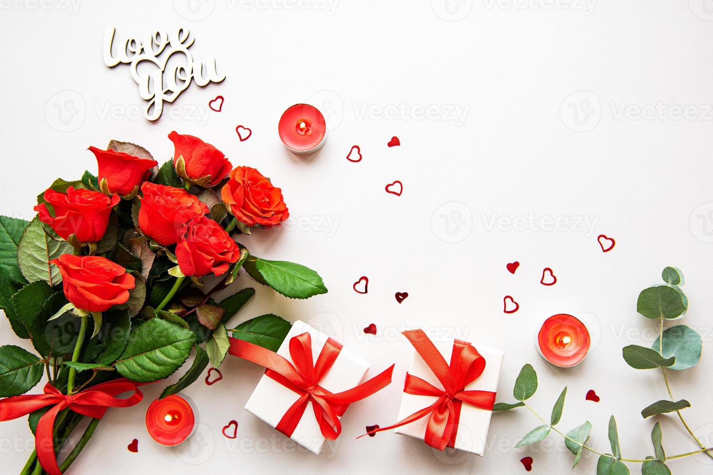 Red roses and gift boxes photo