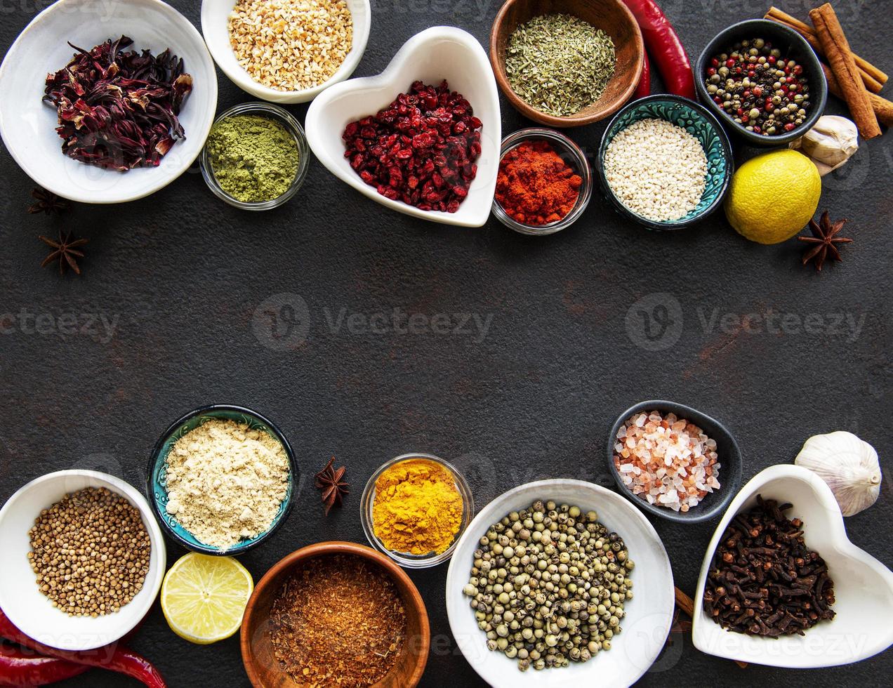 Various spices in a bowls on a black photo