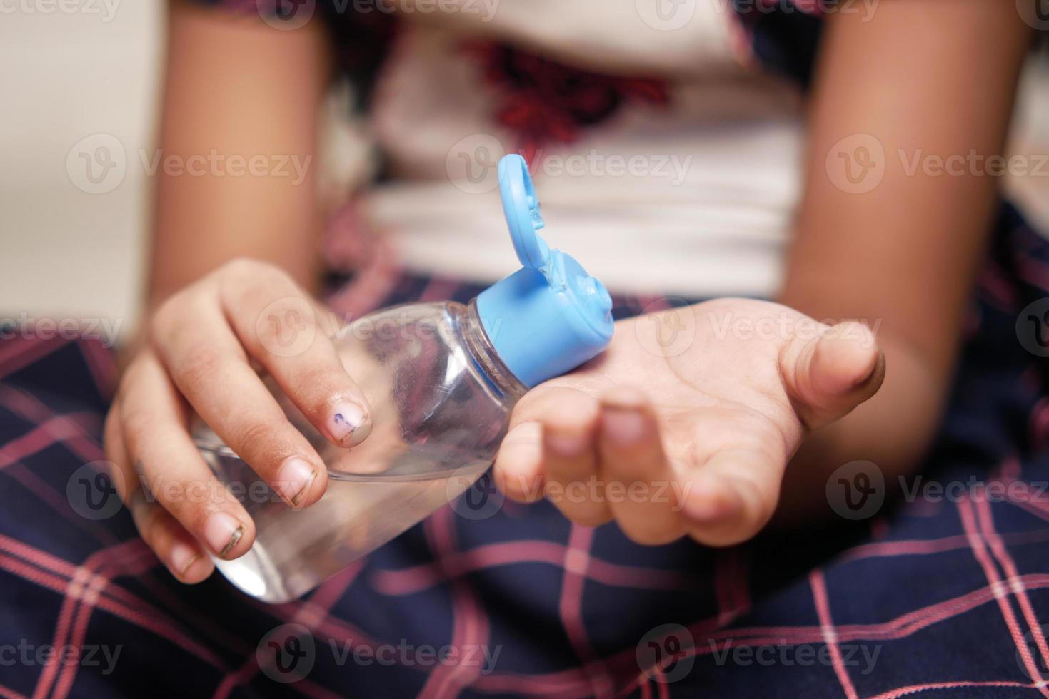 child hand using sanitizer gel for preventing virus with copy space photo