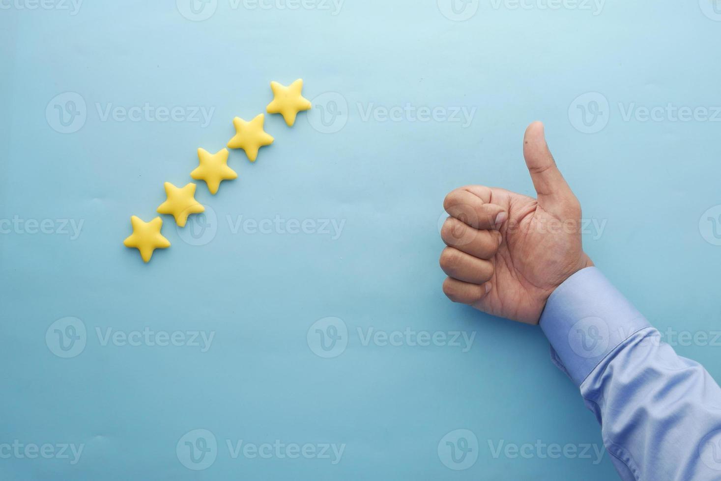 Customer review concept. Rating golden stars on blue background photo