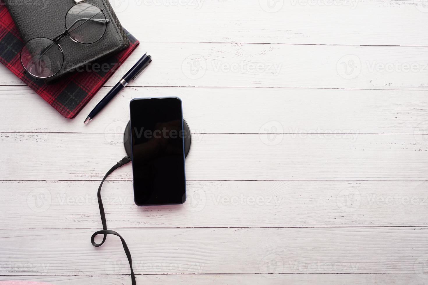 charging Smartphone using Wireless Charging Pad, top view photo