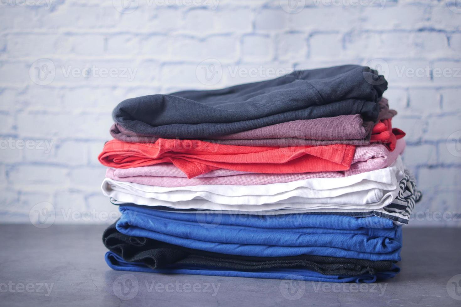 close up of stack of clothes on table . photo