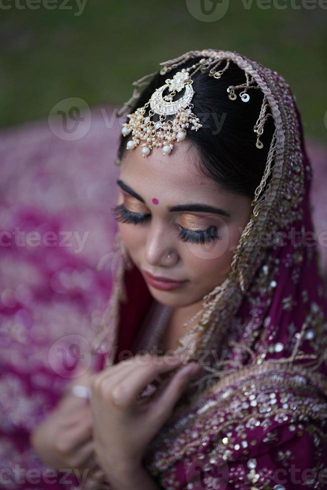 indian bridal wearing pink dress photo