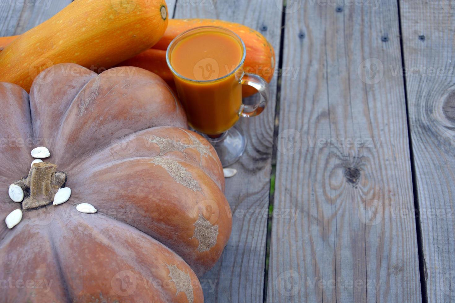 Pumpkin juice on a wooden background. Diet foods. photo