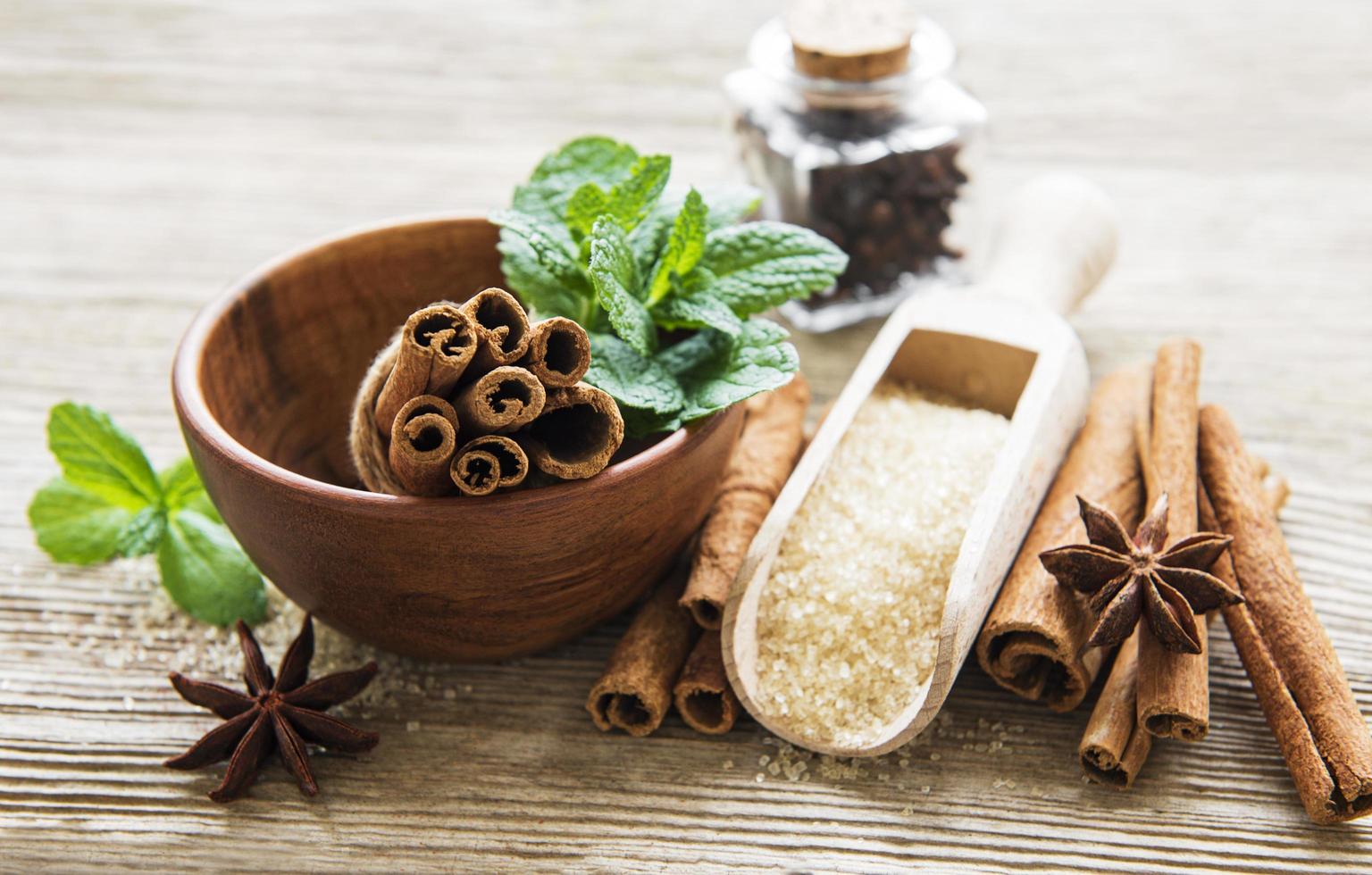 Cinnamon sticks, star anise and brown sugar on a wooden table photo