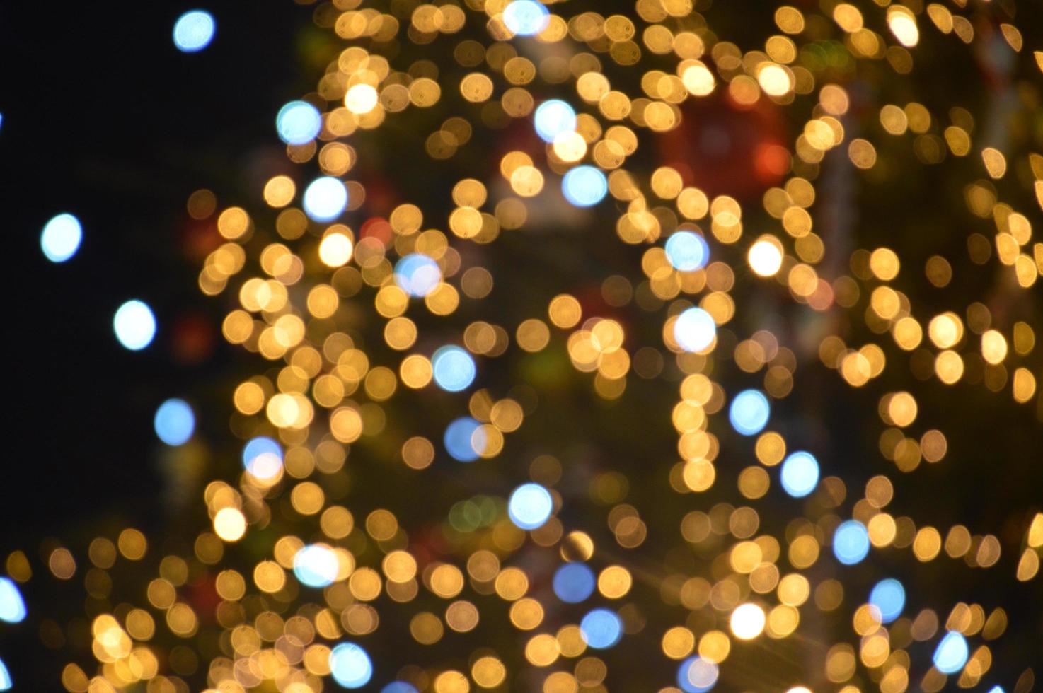 Las guirnaldas borrosas de año nuevo brillan por la noche en composición foto