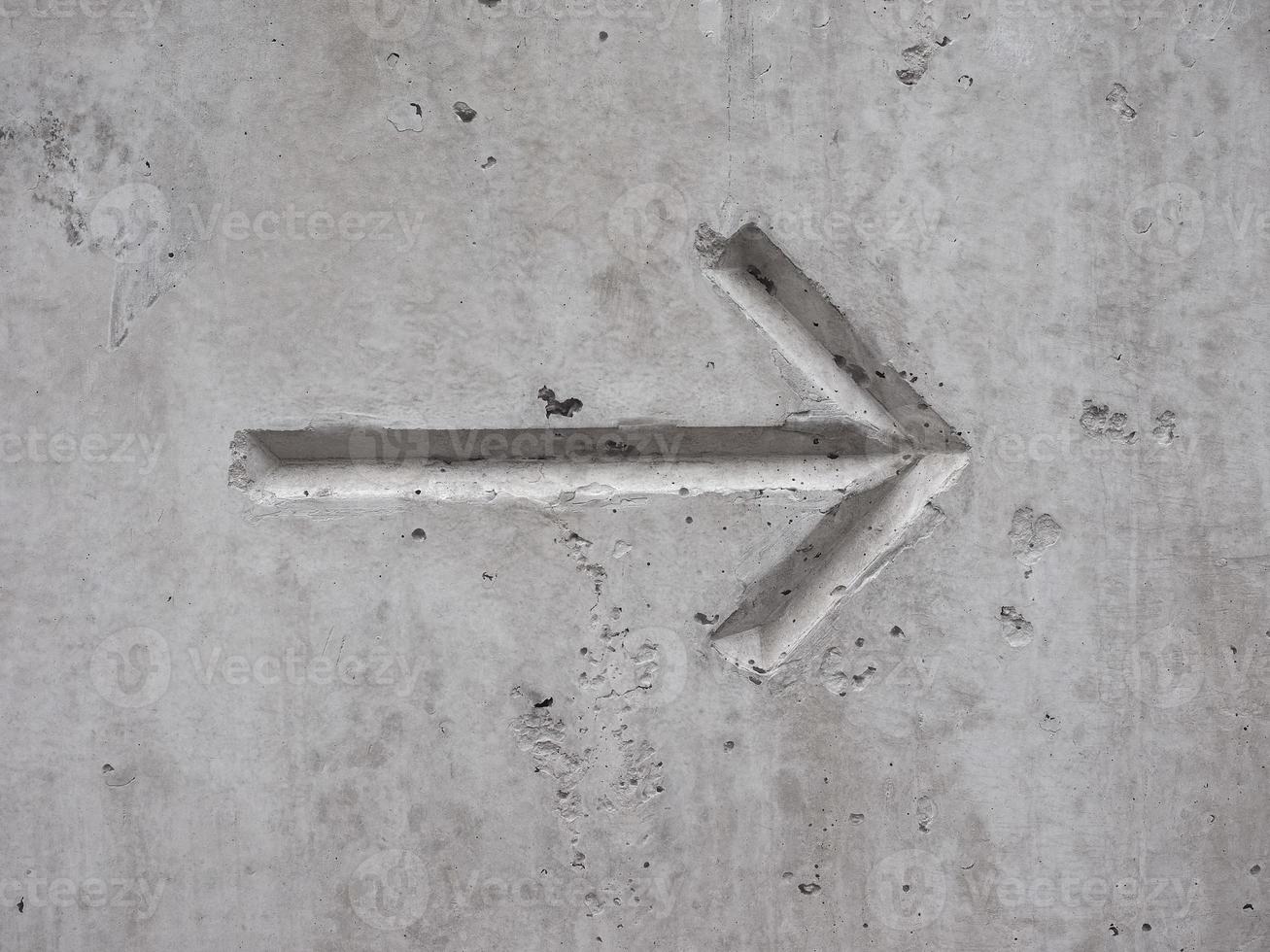 arrow on concrete photo