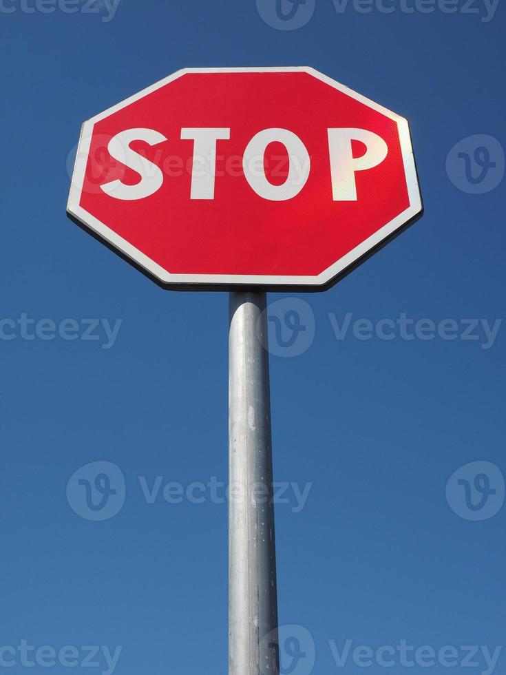 stop sign over blue sky photo