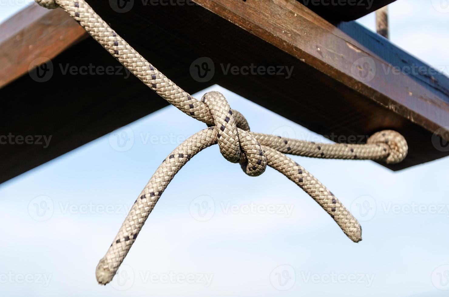 lots of ropes and a big knot against the blue sky photo