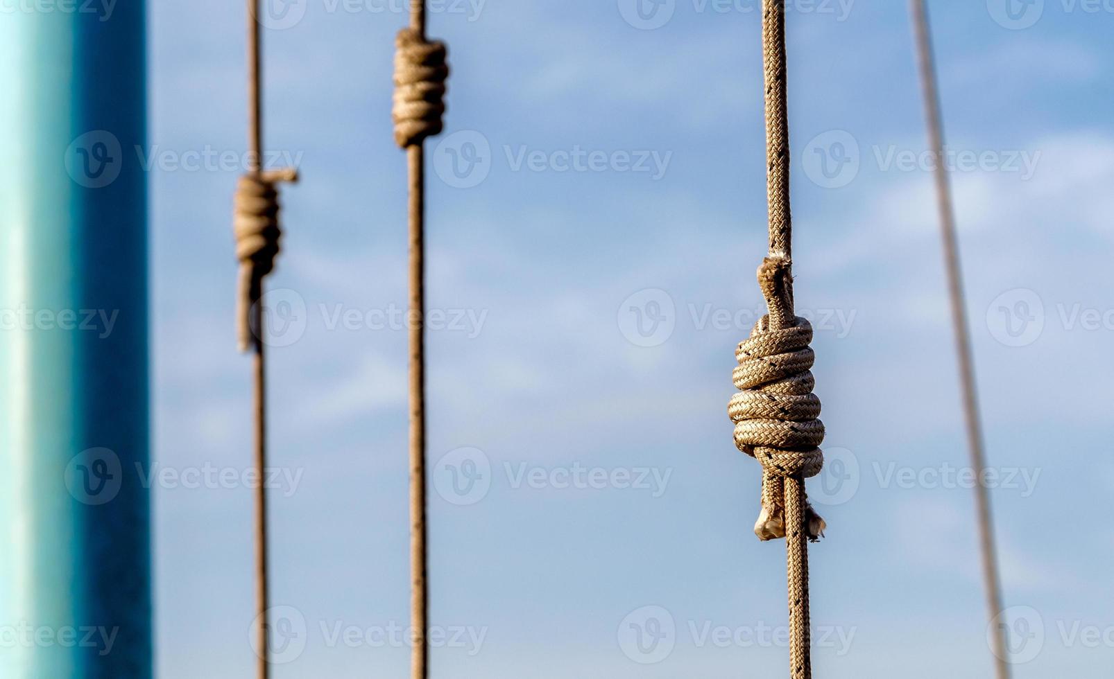 lots of ropes and a big knot against the blue sky photo